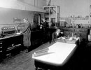 Mr. Legg and two assistants in the chemical laboratory